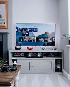 a flat screen tv sitting on top of a entertainment center