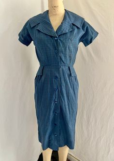 1950s blue plaid shirt dress. Great shawl collar. Buttons all the way down the center front. Wear it open or closed. Repair under right arm. Cotton. Great condition. Washed and ready to wear.  MEASUREMENTS (taken flat, double when appropriate) Ptp 18 Waist 13 Hips 18 Length 40.5 This is the perfect unique gift for a loved one, or yourself! Please be sure to email all questions before purchasing as I do not take returns. International shipping is available!  As always, I am here to answer questio Plaid Cotton Vintage Dress, 1950 Shirtdress, Vintage Cotton Gingham Plaid Dress, Blue 1950s Style Cotton Vintage Dress, Plaid Dress Vintage, Romantic Maxi Dress, Light Blue Plaid, Blue Plaid Dress, 1950s Blue Cotton Dress