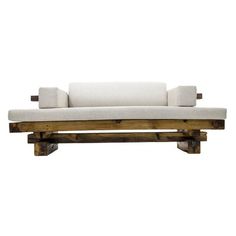 a white couch sitting on top of a wooden frame