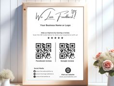 a wooden frame with a qr code on it next to a vase and flowers