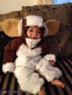 a little boy dressed as an elephant sitting on a couch