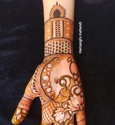 a henna design on someone's hand that is decorated with flowers and circles