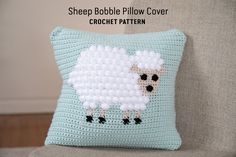 a crocheted sheep pillow on a couch with the words sheep bubble pillow cover written across it