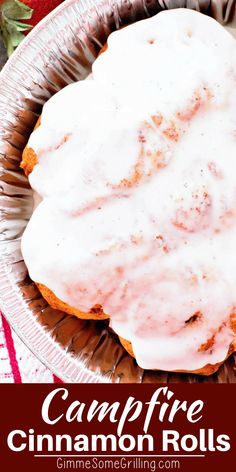 a cinnamon roll with icing in a metal pan