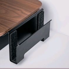 a close up of a wooden table with black metal brackets on the top and bottom