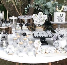 a table topped with lots of cakes and cupcakes