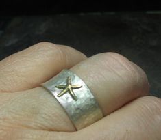 "Starfish ring - express your inner beachcomber with this cute little sterling silver starfish ring! A golden brass starfish rests on a background of brushed sterling silver to bring a hint of the beach to your day. A perfect little ring comfortable to wear and easy to mix and match with many styles both dressy and casual. The ring is 10mm wide (3/8\"), and has been hammered with a texture to remind of the dappled surface of a tidal pool. The finish is a brushed satin finish that allows the star Soldering Rings, Summer Jewelry Beach, Starfish Ring, Tidal Pool, Casual Rings, Stella Marina, Jewelry Beach, Tide Pools, Beach Combing