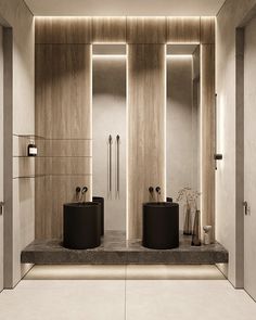 a bathroom with two sinks and mirrors on the wall