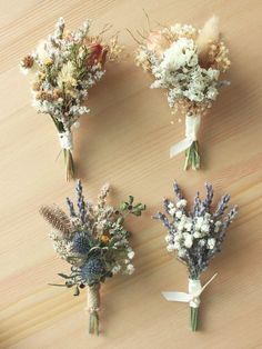 four different types of flowers on a wooden surface