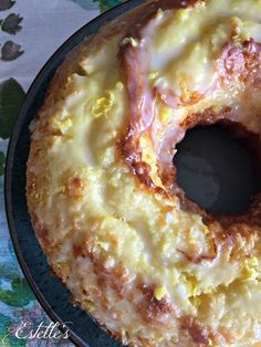 a glazed doughnut sitting on top of a pan covered in icing and toppings