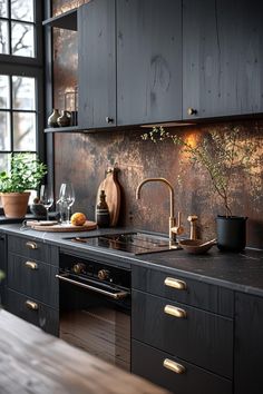 a kitchen with wooden cabinets and black counter tops, gold pulls on the faucet