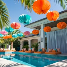 an outdoor pool with paper lanterns hanging from the ceiling