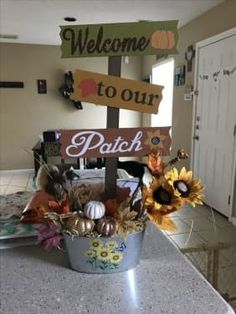 a potted plant sitting on top of a counter next to a sign that says welcome to tour