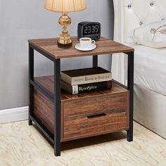 a bedside table with two drawers and a clock on top