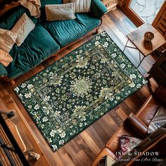 an overhead view of a living room with green couches and rugs on the floor