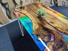 a table made out of wood with a plant on top