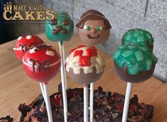 there are four cake pops that look like they have been made to look like cartoon characters