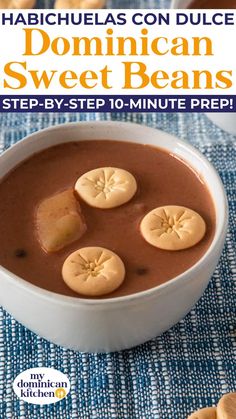 a white bowl filled with chocolate pudding and sliced bananas on top of a blue table cloth