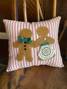 a decorative pillow with two gingerbreads on it