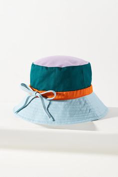 Teaming up just made sense. Honoring the classic craftsmanship of Gola and the creative spirit of Anthropologie, together we designed an exclusive collection of leisurewear to elevate your every day. Whether you're hitting the beach or hitting the town, this bucket hat is the perfect companion, featuring a colorblock design and an oh-so-sweet back bow. | x Anthropologie Colorblock Bow Bucket Hat by Gola in Blue, Women's, Cotton British Heritage, Bucket Hats, Heritage Brands, Leisure Wear, Exclusive Collection, Color Coding, Home Art, Color Blocking, Bucket Hat