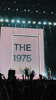 the band the 1970 is performing on stage with their hands up in front of an audience