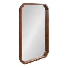 a large wooden mirror on a white background