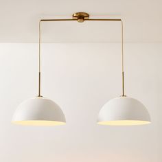 two lights hanging from the ceiling in a room