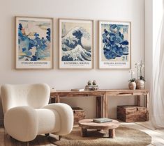 a living room with three paintings on the wall