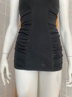 Gorgeous 1950's one piece swim suit in black. Elasticity is excellent, heavily rouched and very flattering! Could use a long bath to take some dusty spots off. Zips up the back, hook and eye to aid in zipping. Has adjustable straps with buttons. Kerrybrooke seas stars brand Size xs (Fit the 34x24x34 mannequin well!) Black Ruched Tankini For Beachwear, Black Ruched Tankini For Swimming, Sleeveless Ruched Tankini For Party, Ruched Tankini For Party, Party Fitted Swimwear With Ruched Sides, Fitted Party Swimwear With Ruched Sides, Fitted Swimwear With Ruched Sides For Party, Ruched One-piece Tankini For Party, Black Ruched Swimwear For Party