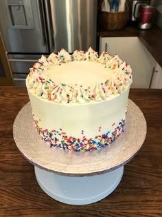 a cake with white frosting and sprinkles