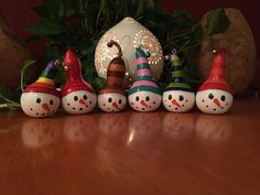 a group of snowmen sitting on top of a wooden table