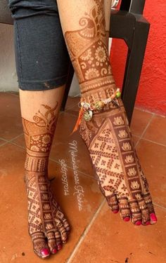 the legs and feet of a woman with henna tattoos