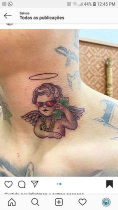 a woman's chest with an angel tattoo on it