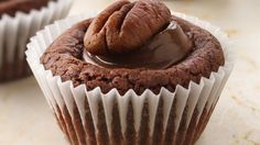 two chocolate cupcakes sitting on top of each other