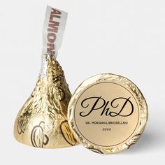 a gold foiled chocolate candy with the word ph d on it