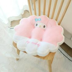 a hello kitty pillow sitting on top of a wooden chair