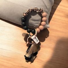 a bracelet with a tassel hanging from it's end on top of a pillow