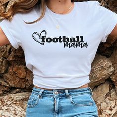 Show your loving support with this fun Football Mama heart design t-shirt. Perfect for proud football moms celebrating the bond between mom and child. Wear it to games, practices, or just to express your football mom pride! This classic unisex jersey short sleeve tee fits like a well-loved favorite. Soft cotton and quality print make users fall in love with it over and over again. These t-shirts have-ribbed knit collars to bolster shaping. The shoulders are tapered for a better fit over time. Du Sporty Short Sleeve Tops For Mother's Day, Family Matching Letter Print T-shirt For Game Day, Sporty White T-shirt For Mother's Day, White Sporty T-shirt For Mother's Day, Heart Divided Football Shirts, Mother's Day Sports T-shirt With Letter Print, Mother's Day Heart-shaped T-shirt With Letter Print, Somebody’s Loud Mouth Soccer Mama, White Heart Print T-shirt For Mother's Day