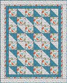 a blue and white quilt with orange birds on the border, in front of a polka dot