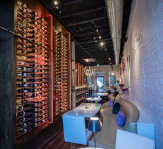 the wine cellar is filled with many different types of bottles and glasses on display in rows