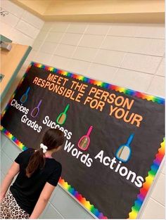 a girl standing in front of a sign that says meet the person responsible for your choice