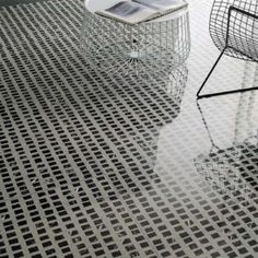 two chairs sitting next to each other on top of a floor covered in metal grates