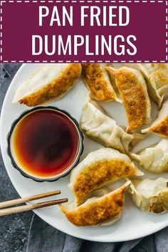 a plate with dumplings, dipping sauce and chopsticks on the side that says pan fried dumplings