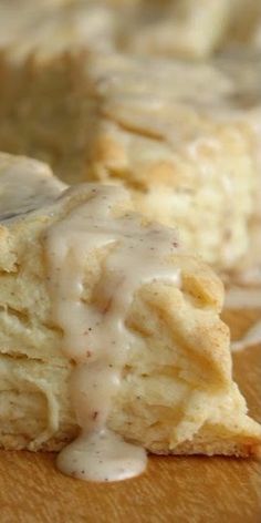 biscuits covered in gravy sitting on top of a cutting board