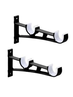 two black and white wall mounted brackets on the side of each other, with one light on