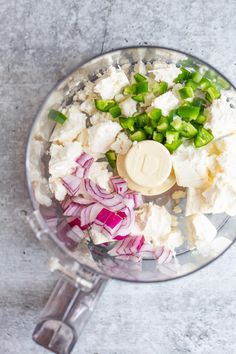 an overhead view of a food processor with onions, celery and other ingredients