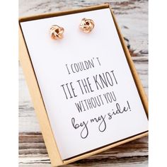 a pair of gold earrings sitting on top of a white card that says i couldn't tie the knot without you buy my side