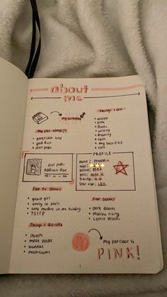 an open notebook with writing on it and some other things in the page next to it