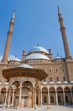 an ornate building with two large towers in the background