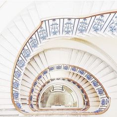 a spiral staircase with blue and white tiles on it